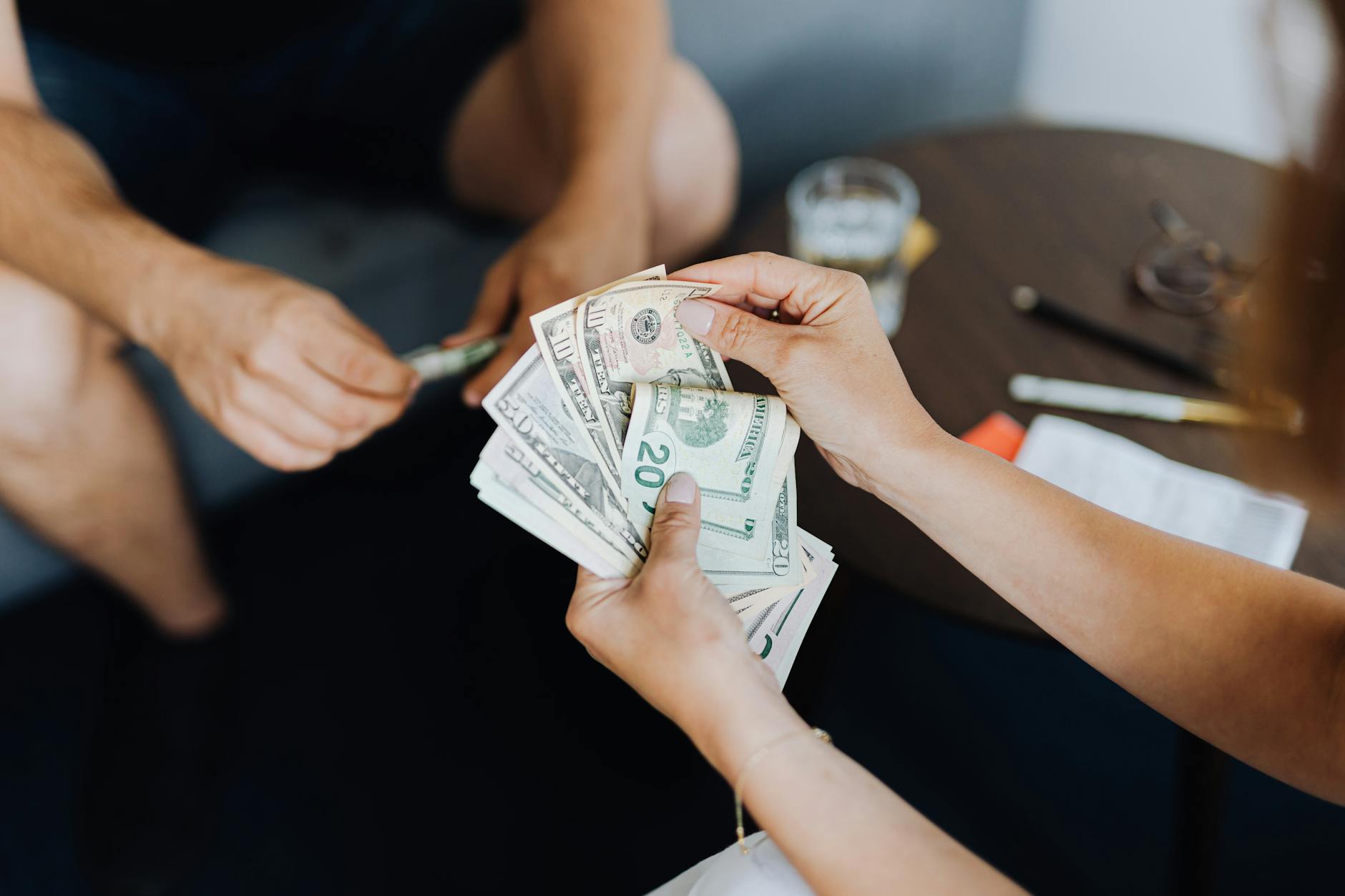 person counting dollar bills