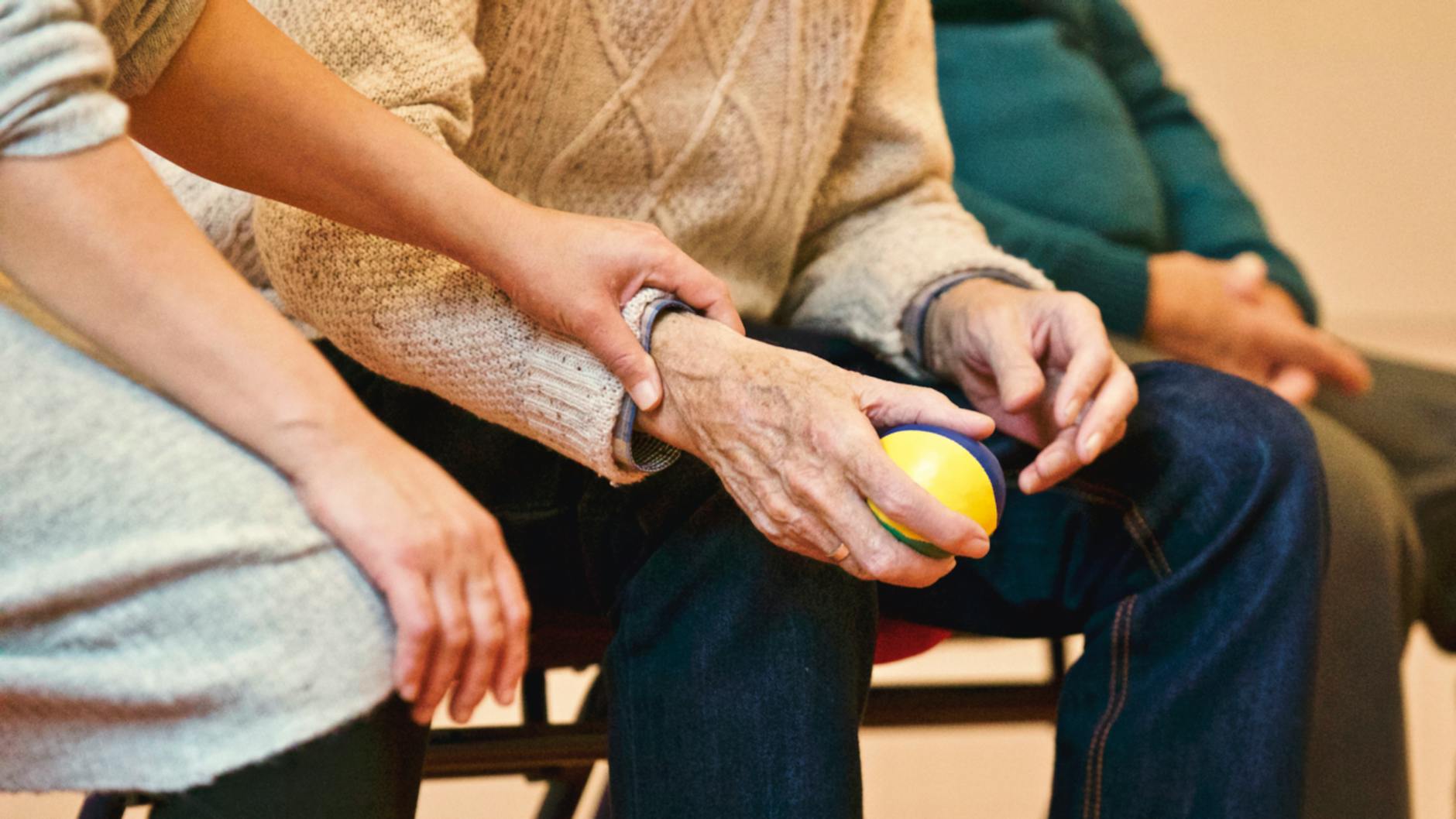 person holding a stress ball reviewing health insurance