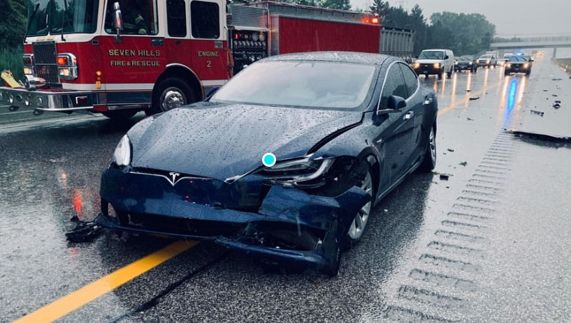 Image of a Tesla car involved in an accident, illustrating the importance of car insurance